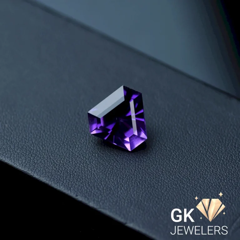 Laser cut purple amethyst gemstone on a surface