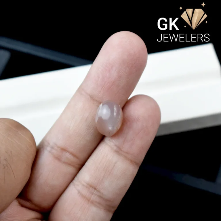 A person holding a natural moonstone