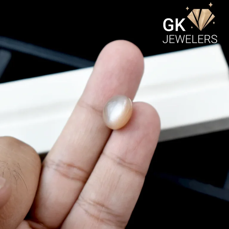 Natural moonstone held between fingers