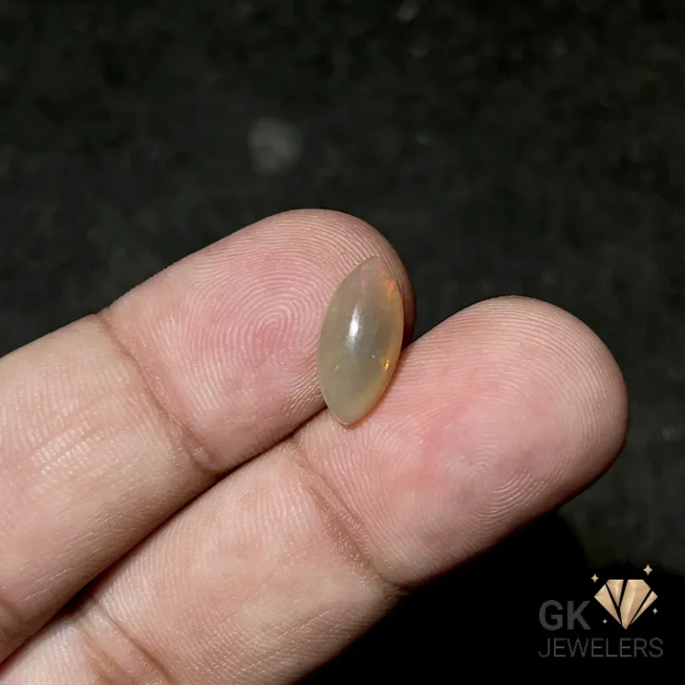 Teardrop opal gemstone held between fingers