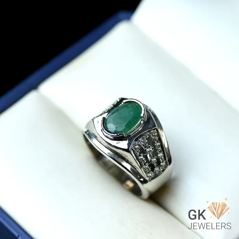 Sterling silver ring with oval emerald and diamond accents