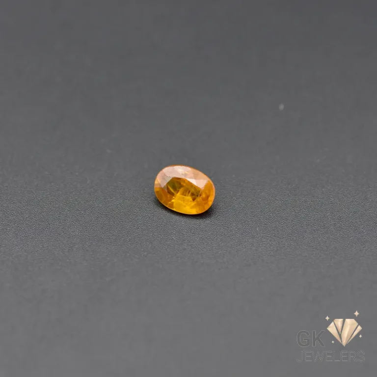 Oval-cut orange citrine gemstone on dark gray background