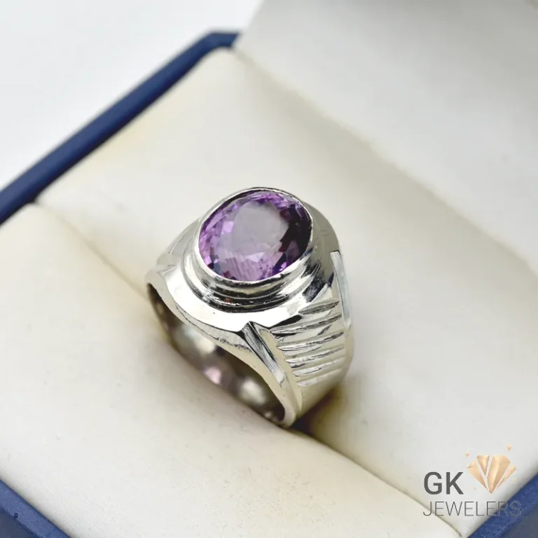 Oval-cut natural amethyst gemstone set in handmade silver ring with detailed engravings, size 22
