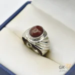 Handmade silver ring featuring a round, brown opal gemstone with translucent properties, weighing 9.62g and set in a decorative band