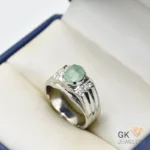 Silver ring featuring a 3+ carat oval-cut Zambian emerald gemstone with light green color and semi-transparent clarity, handmade setting, size 21