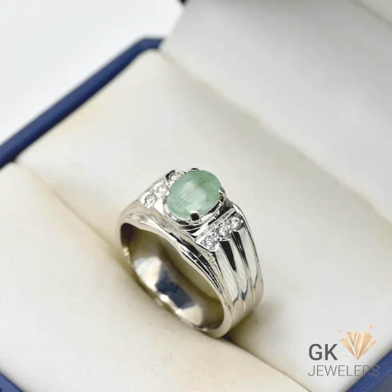Silver ring featuring a 3+ carat oval-cut Zambian emerald gemstone with light green color and semi-transparent clarity, handmade setting, size 21