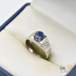 Oval blue sapphire gemstone set in a silver ring with handmade setting and textured band, weighing 6.15g, size 22