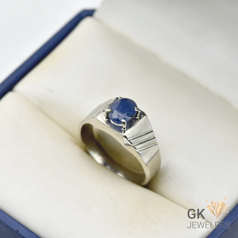 Oval blue sapphire gemstone set in a silver ring with handmade setting and textured band, weighing 6.15g, size 22