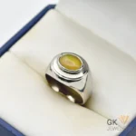 Silver ring featuring a 2.5+ carat oval white opal gemstone with translucent properties, handmade setting, and milky white base with play-of-color