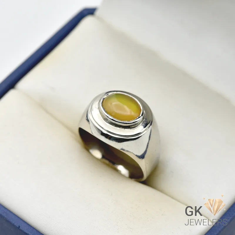 Silver ring featuring a 2.5+ carat oval white opal gemstone with translucent properties, handmade setting, and milky white base with play-of-color