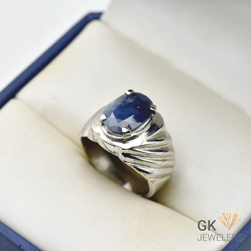 Oval-cut blue sapphire gemstone set in a handmade silver ring with a 9.91g band, originating from Sri Lanka