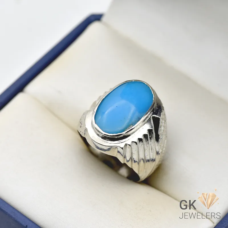 Turquoise Feroza Silver Ring for Men Oval-shaped natural turquoise gemstone set in a handmade silver ring with ornate details, displayed on a white jewelry box interior