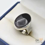 Oval black agate gemstone set in a handmade silver ring with intricate details, weighing 12.25 grams