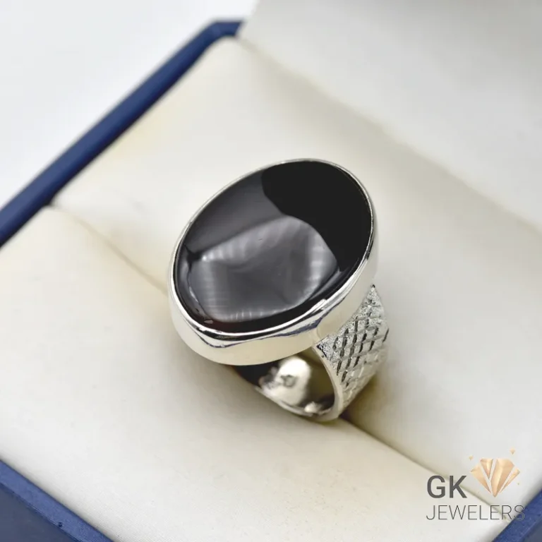 Oval black agate gemstone set in a handmade silver ring with intricate details, weighing 12.25 grams
