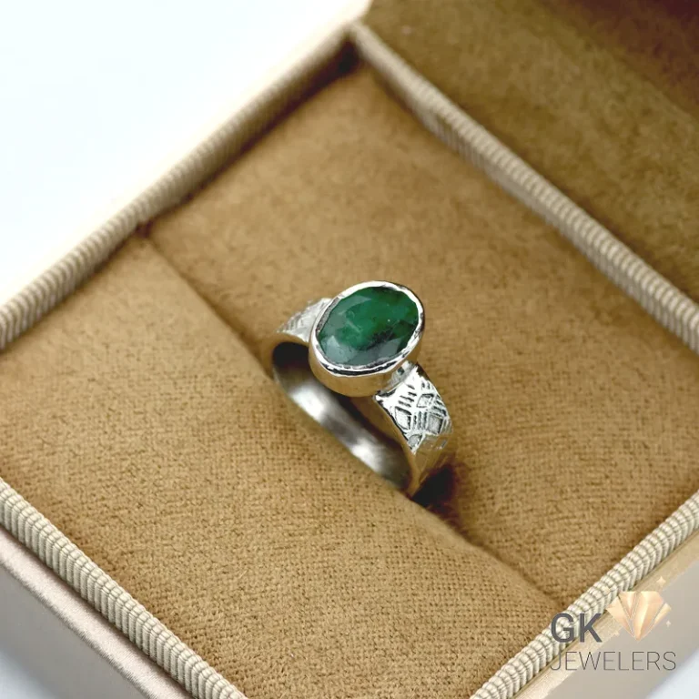 Silver ring featuring a vibrant oval-cut emerald gemstone from Zambia, set in handmade 925 sterling silver with translucent green color
