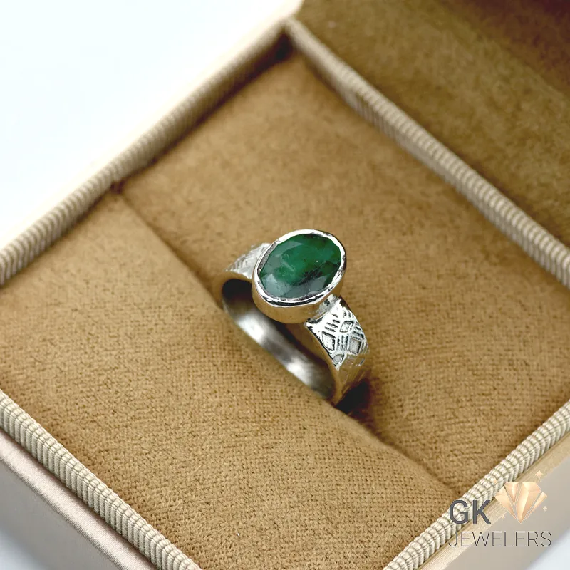 Silver ring featuring a vibrant oval-cut emerald gemstone from Zambia, set in handmade 925 sterling silver with translucent green color