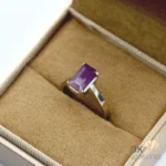 Purplish-red African ruby gemstone in emerald cut, set in handmade silver ring, size 15