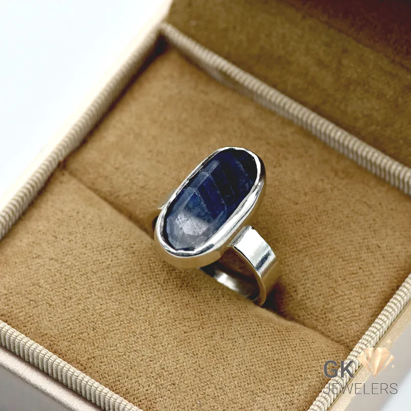 Translucent oval-cut blue sapphire gemstone set in handmade silver ring, Afghanistan origin, size 16