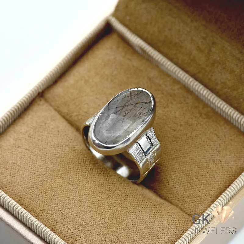 Oval black Muh-e-Najaf quartz gemstone in a handmade silver ring setting, semi-translucent with visible inclusions