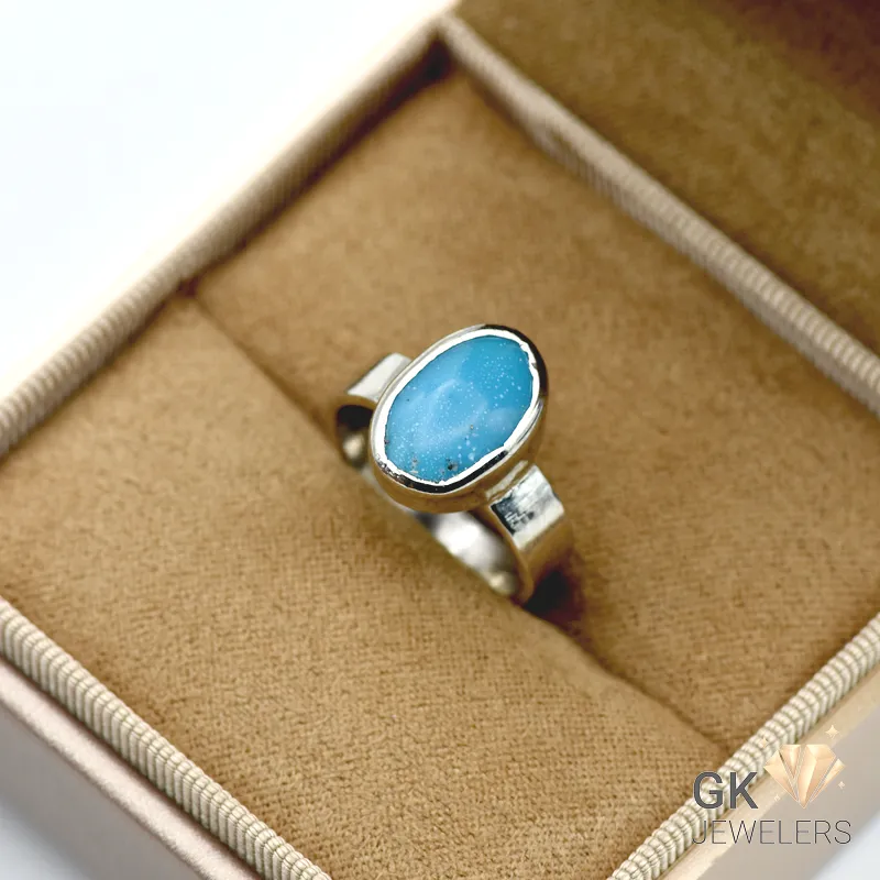 Handmade silver ring featuring an oval-cut natural turquoise gemstone from Iran, set in sterling silver with opaque blue color