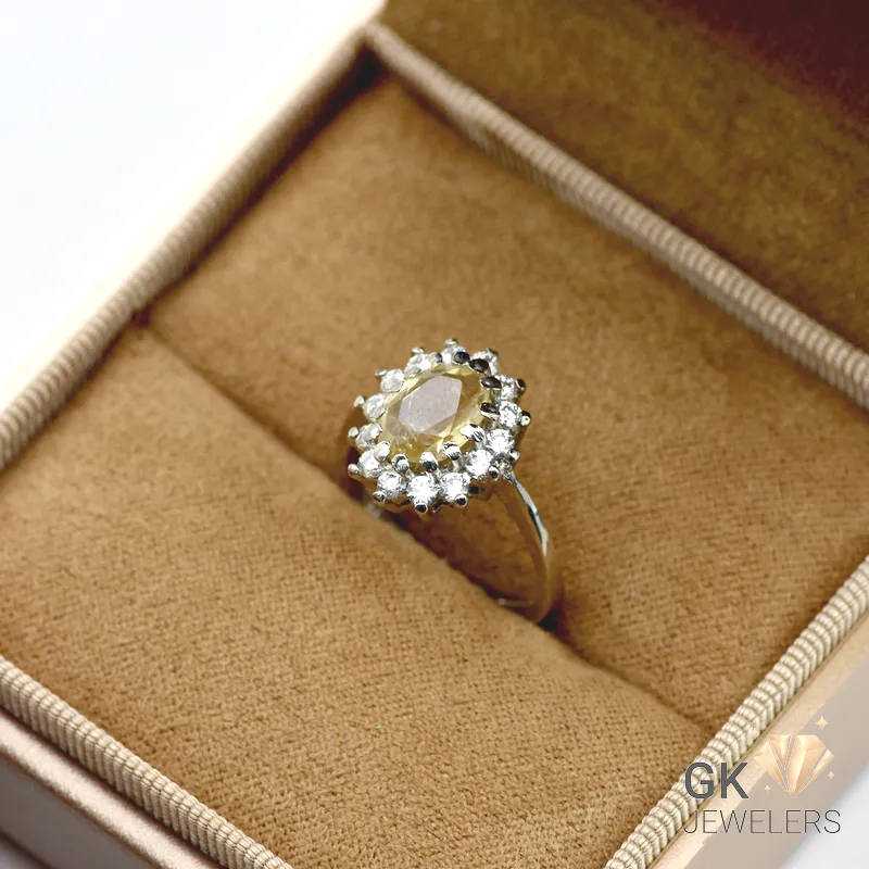 Oval-cut natural citrine gemstone surrounded by diamonds in a 925 silver handmade ring setting