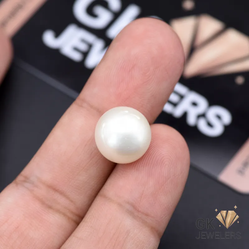 Hand holding a large 12.25ct white natural pearl from Africa