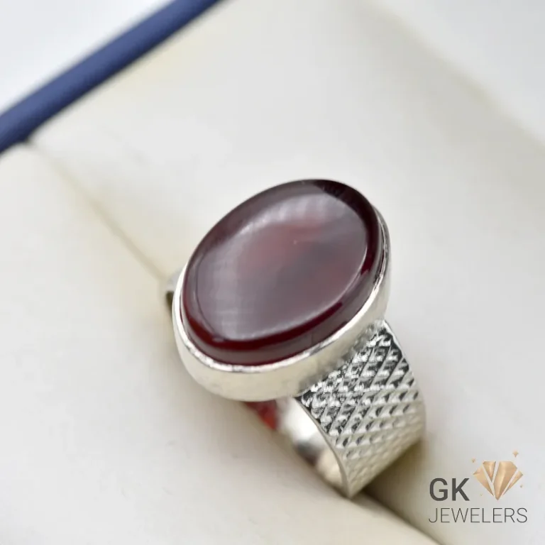 Dark brown oval agate gemstone set in a handmade sterling silver ring with textured band, weighing 8.81g