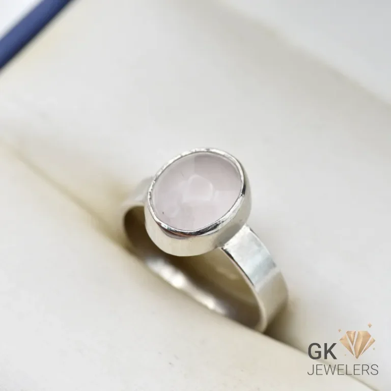 Handmade silver ring featuring a round, translucent African rose quartz gemstone in a simple bezel setting, weighing 4.46g