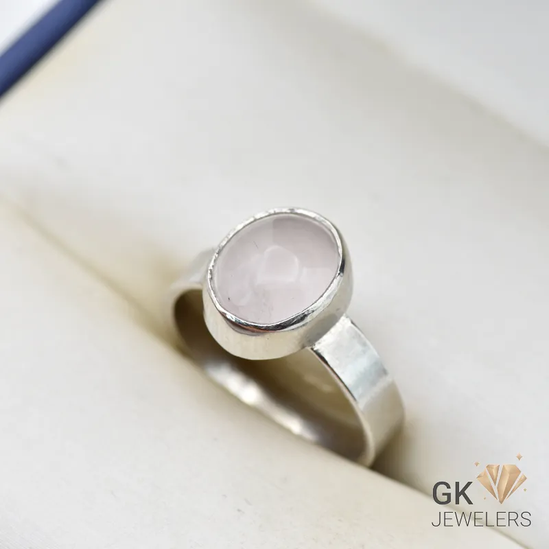 Handmade silver ring featuring a round, translucent African rose quartz gemstone in a simple bezel setting, weighing 4.46g