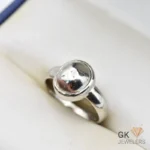 Oval pyrite gemstone set in handmade silver ring, size 19, with metallic luster on a white background