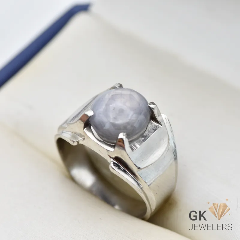 Silver ring featuring a round blue star sapphire gemstone with asterism, handmade setting, size 21