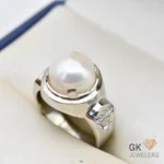 Handmade silver ring featuring a lustrous white round pearl from Africa, set in a decorative silver band with small diamonds