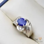 Sterling silver ring featuring an oval-shaped natural lapis lazuli gemstone from Afghanistan, set in a handmade four-prong setting with decorative details