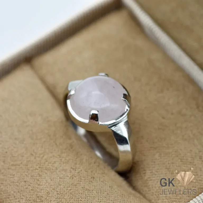Silver ring featuring a round, translucent rose quartz gemstone from Africa, set in a handmade bezel setting
