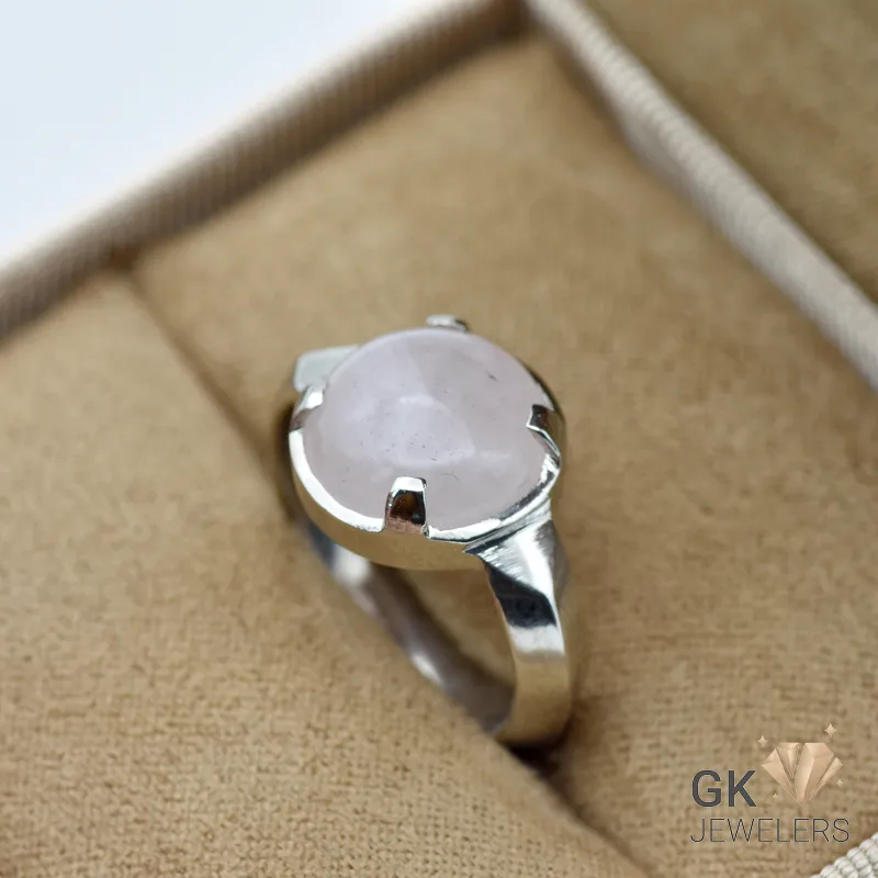 Silver ring featuring a round, translucent rose quartz gemstone from Africa, set in a handmade bezel setting