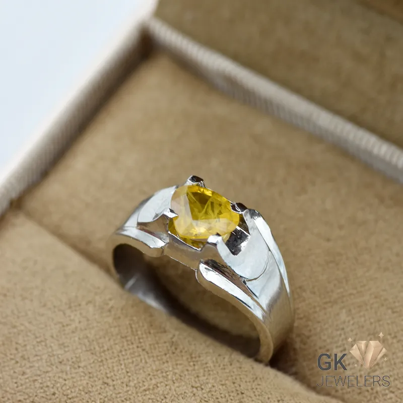 Silver ring featuring a transparent yellow sapphire (pukhraj) gemstone from Madagascar, set in a handmade silver (chandi) band, size 18