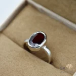 Oval-cut red garnet gemstone set in handmade silver ring, size 14, originating from Africa