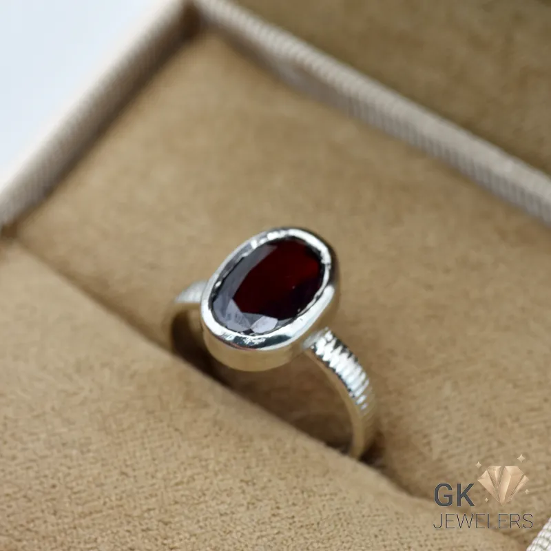 Oval-cut red garnet gemstone set in handmade silver ring, size 14, originating from Africa
