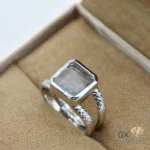 Transparent square-cut aquamarine gemstone set in handmade silver ring with twisted band details