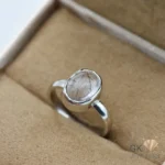 Oval-cut transparent black quartz gemstone in a handmade silver ring, size 13, with a simple setting
