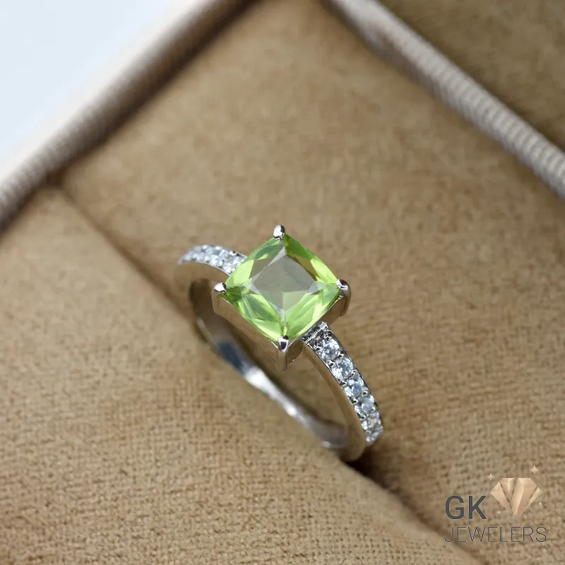 Silver ring featuring a square-cut transparent green peridot gemstone from Afghanistan, with small diamonds on the band, size 12