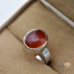 Red agate gemstone set in handmade sterling silver ring, size 14, originating from Iran, displayed on tan velvet jewelry box