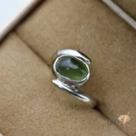 Oval-cut natural Russian jade gemstone set in handmade silver ring, size 14, translucent green color