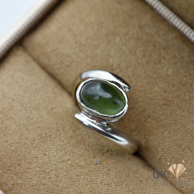Oval-cut natural Russian jade gemstone set in handmade silver ring, size 14, translucent green color