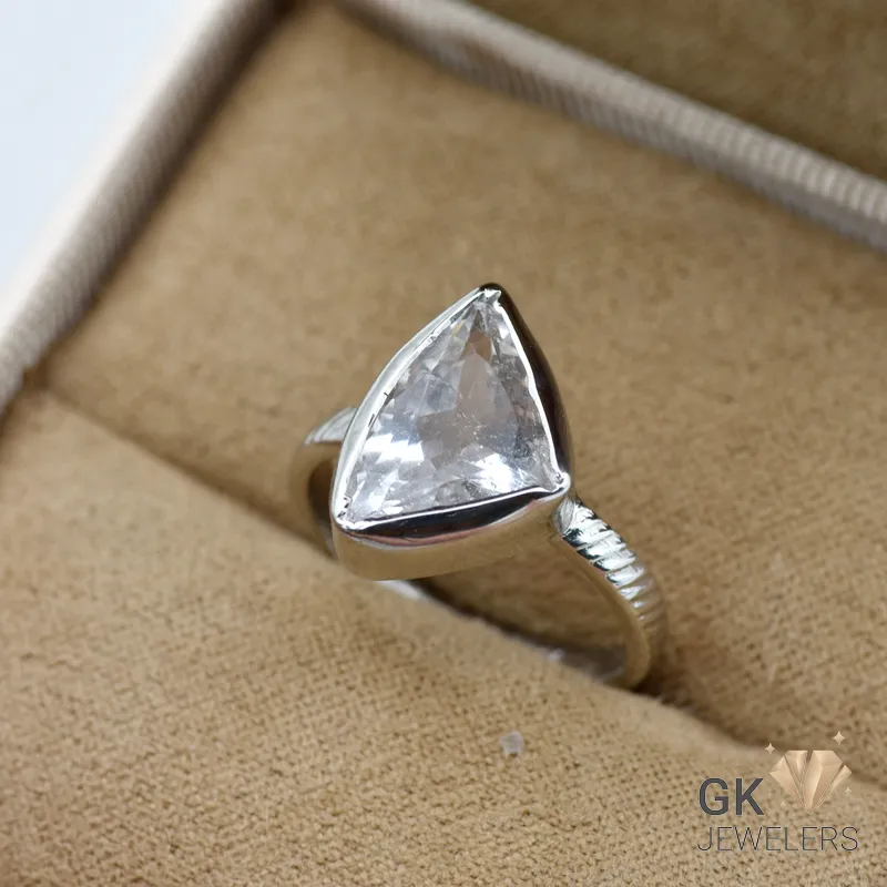 Silver ring featuring a large, transparent triangular aquamarine gemstone from Afghanistan, set in a handmade sterling silver band