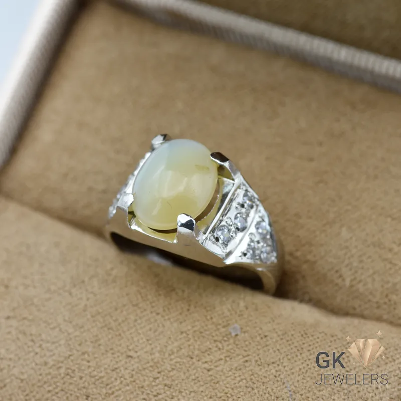 Silver ring featuring a translucent white Ethiopian opal gemstone in a handmade setting, displayed in a jewelry box