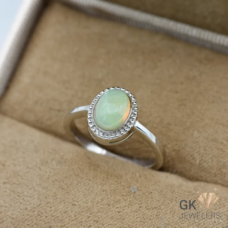 Silver ring featuring a semi-transparent green opal gemstone from Ethiopia, set in a handmade bezel with diamond accents