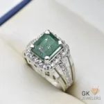 Silver ring featuring a square-cut emerald gemstone surrounded by diamonds, set in a handmade sterling silver band, size 22