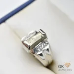 Silver ring featuring a natural pyrite gemstone with gray metallic luster, handmade setting, and diamond details