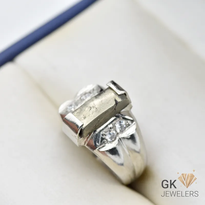 Silver ring featuring a natural pyrite gemstone with gray metallic luster, handmade setting, and diamond details